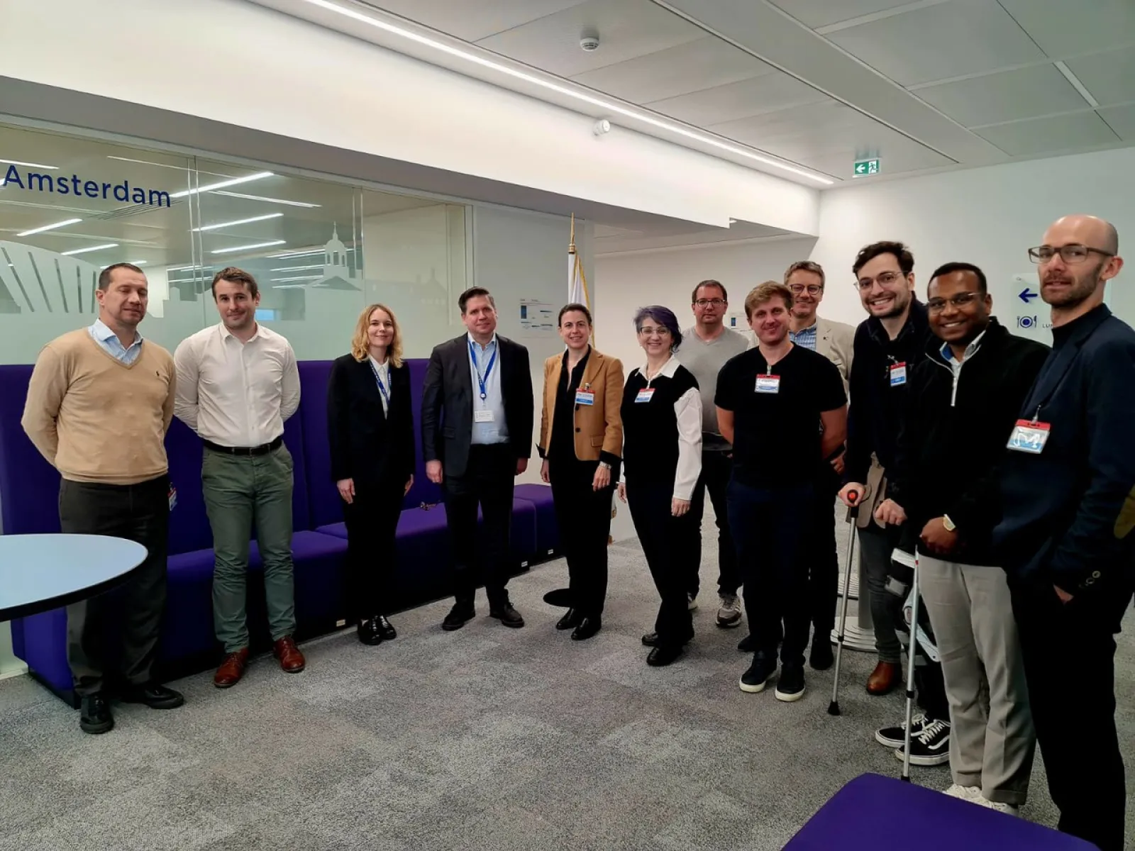 Gruppe von Studierenden und Dozenten des Executive Master of Laws (LL.M.) im Wirtschaftsstrafrecht der Universität Liechtenstein bei einer Studienreise im Europarat in Straßburg, stehend in einem modernen Konferenzraum.