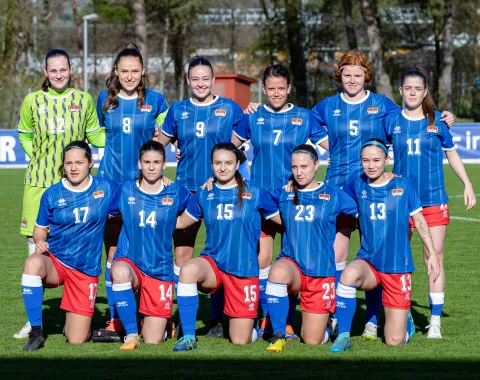Teamfoto der Frauen Nationalmannschaft Liechtenstein auf dem Fussballfeld in blauen Trikots
