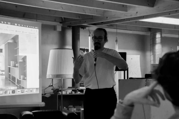 Schwarz-Weiss Aufnahme eines Mannes mit einem Mikrofon in der Hand